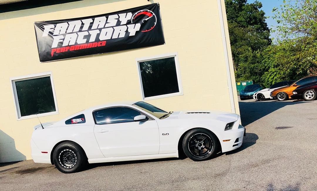 Photograph of the shop building, prominently featuring the shop's vibrant banner that displays its brand identity. Photograph of the shop building, prominently featuring the shop's vibrant banner that displays its brand identity.